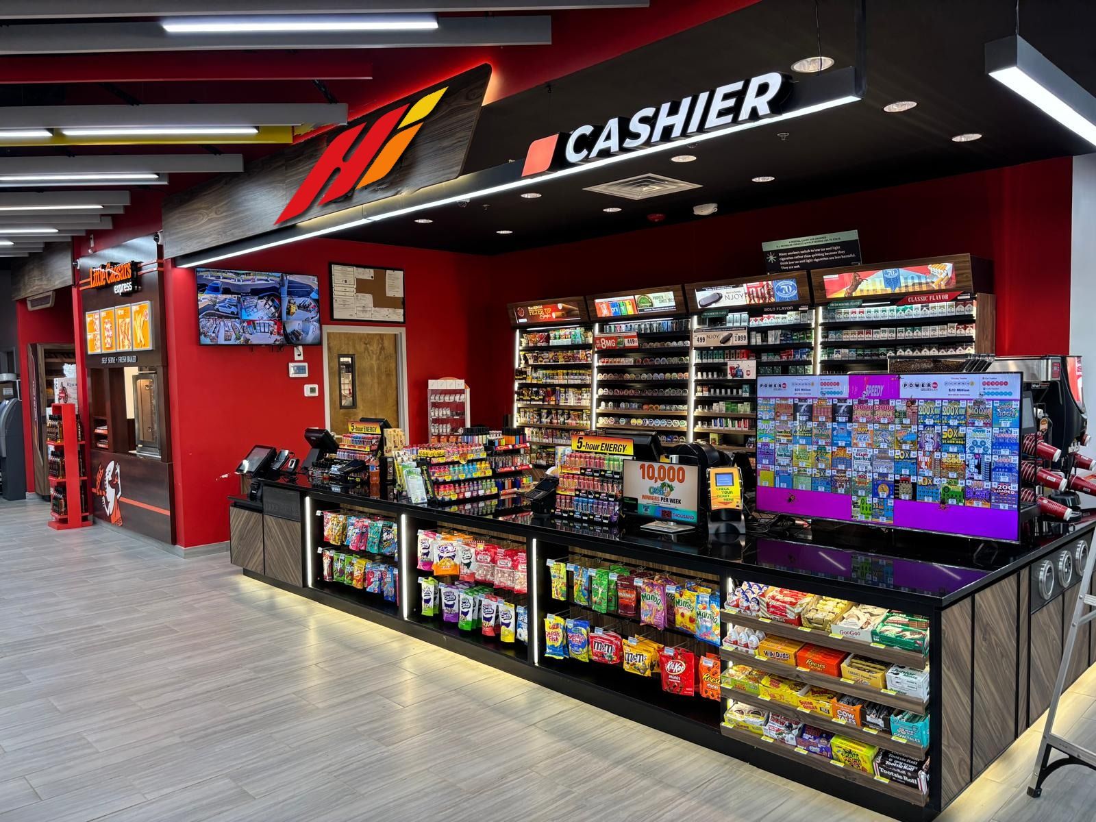 The cashier counter under the Hi monogram on the red wall, with the Little Caesars Express counter to the left