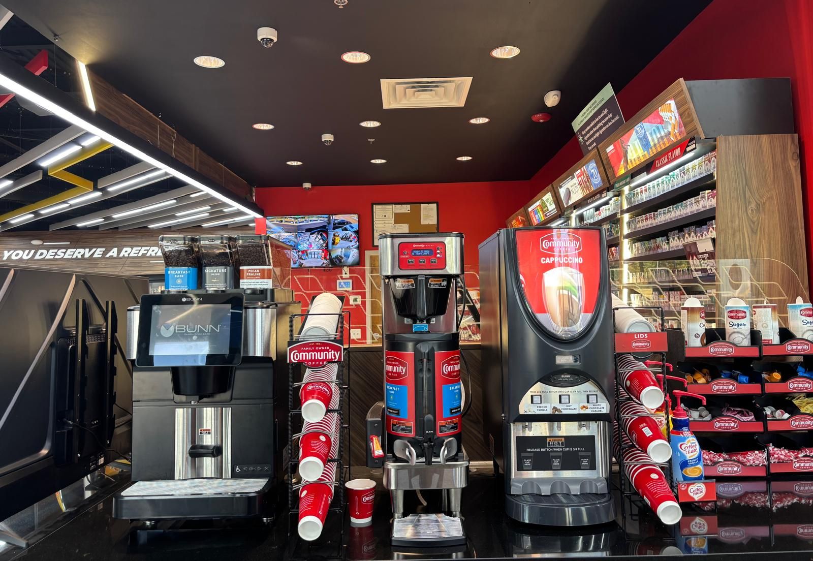 The coffee bar: Bunn brewers, Community Coffee and a cappuccino machine on a black counter