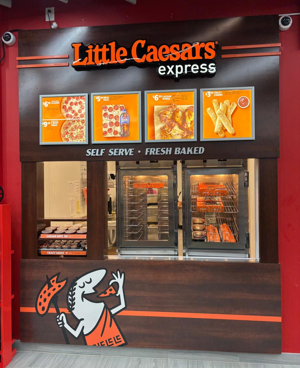 The Little Caesars Express counter inside the store: the menu board and the self-serve warmer